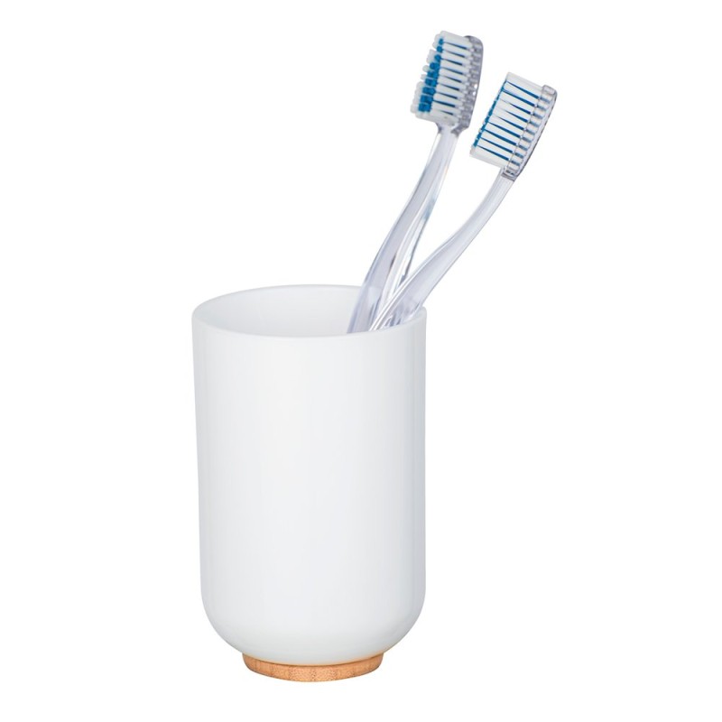 El vaso para cepillos de dientes Posa en sobrio color blanco y sobre el las vistosas combinaciones de bambú crean un ambiente na