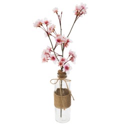 este magnífico cerezo artificial "Dream" es de cristal transparente y sostiene una rama de cerezo en flor, sujeta por un corcho.