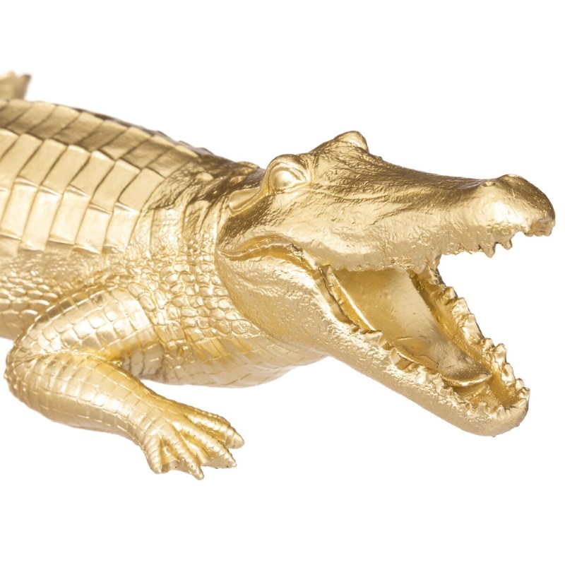 Figura decorativa de cocodrilo en acabado dorado, ideal para añadir un toque étnico chic a tu espacio. Su diseño llamativo desta