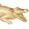 Figura decorativa de cocodrilo en acabado dorado, ideal para añadir un toque étnico chic a tu espacio. Su diseño llamativo desta