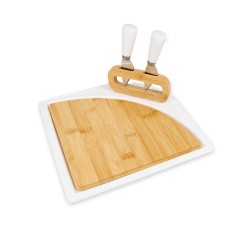 Elegancia y funcionalidad en una sola pieza. Esta tabla para quesos combina cerámica blanca y bambú natural, e incluye dos cuchi
